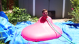 Awesome slow-mo video shows giant water balloon burst with man sat inside