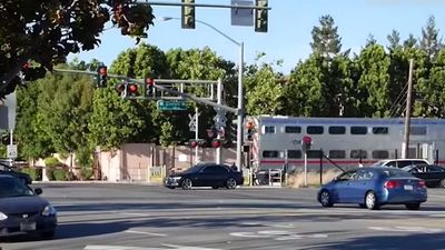 Watch a man pulled from his car seconds before a train hits…