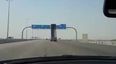 Dump truck smashes through overhanging road sign (video)