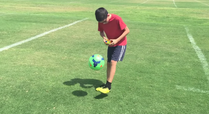 Watch this 11-year-old kid solve a Rubik’s cube while doing keepy-uppies