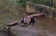 Waist-high floods could not stop this pair finishing their beergarden pints