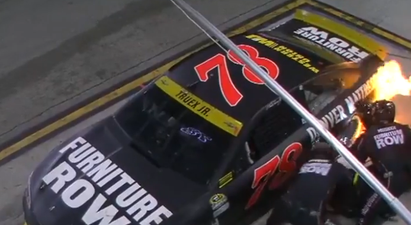 NASCAR pit crew casually change tire whilst the car is on fire