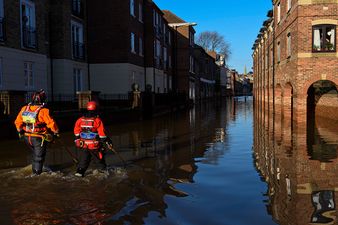 Syrian refugees help to clear up streets and homes ravaged by floods