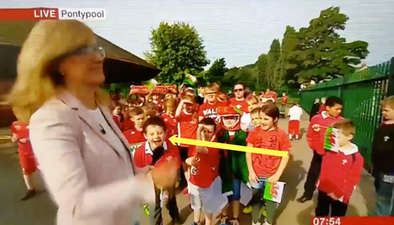 People are loving this little Wales fan who interrupted a news report to cheer on his team