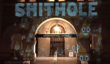 Someone has projected the word shithole onto the front of Trump’s hotel