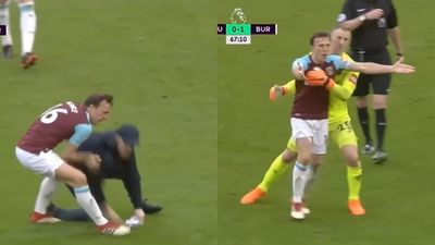 Mark Noble throws West Ham supporter to the ground during pitch invasion