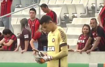 Brazilian goalkeeper checks his phone during league top flight match