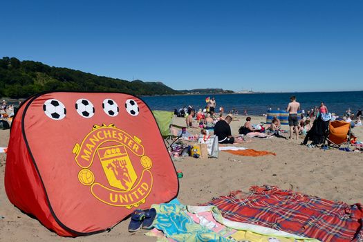 ABERDOUR, SCOTLAND - JULY 03: A Manchester United beach tent on Silver Sands beach as people enjoy the sun at the start of the Scottish school holidays as the heatwave continues, on July 3, 2018 in Aberdour, Scotland. (Photo by Ken Jack - Corbis/Corbis via Getty Images)