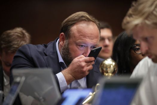 WASHINGTON, DC - SEPTEMBER 5: Alex Jones of InfoWars speaks into his phone during a Senate Intelligence Committee hearing concerning foreign influence operations' use of social media platforms, on Capitol Hill, September 5, 2018 in Washington, DC. Twitter CEO Jack Dorsey and Facebook chief operating officer Sheryl Sandberg faced questions about how foreign operatives use their platforms in attempts to influence and manipulate public opinion. (Photo by Drew Angerer/Getty Images)