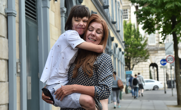 BELFAST, NORTHERN IRELAND - JULY 05: Billy Caldwell and his mother Charlotte react with one another as they return to Belfast on July 5, 2018 in Belfast, Northern Ireland. Billy Caldwell who is severely epileptic had been receiving treatment in London for his condition and had been denied the use of cannabis oil to help his condition. On Tuesday the government said it would reach a decision within the next few weeks on whether laws around medicinal cannabis would be changed. (Photo by Charles McQuillan/Getty Images)