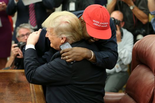 WASHINGTON, DC - OCTOBER 11: (AFP OUT) U.S. President Donald Trump hugs rapper Kanye West during a meeting in the Oval office of the White House on October 11, 2018 in Washington, DC. (Photo by Oliver Contreras - Pool/Getty Images)