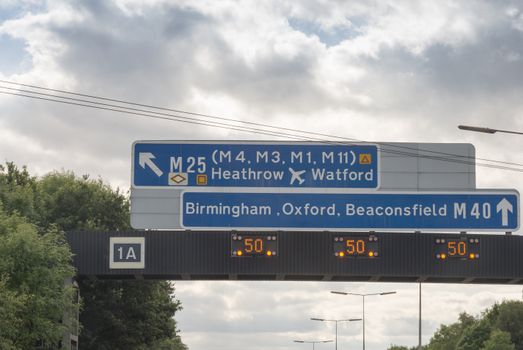 Sign on motorway in England exit to M25 , M40 straight ahead.