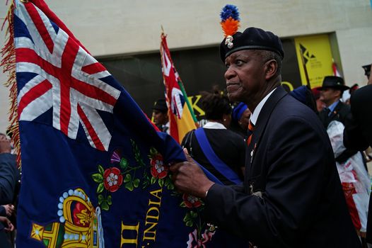 LONDON, ENGLAND - JUNE 22: Flag bearers wait ahead of the unveiling of a memorial honoring the two million African and Caribbean military servicemen and women who served in World War I and World War II, is unveiled in Windrush Square on June 22, 2017 in London, England. The event was attended by war veterans, in-service men and women and dignitaries including the Mayor of London Sadiq Khan, Chiefs of Defence Staff from Caribbean and African countries, High Commissioners from Commonwealth Nations, ambassadors and the Secretary of State for Defence Sir Michael Fallon. (Photo by Dan Kitwood/Getty Images)