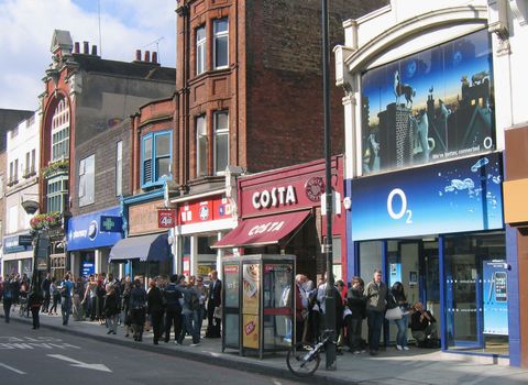 LONDON - JULY 11: Customers queue outside the O2 store in Camden Town on the day of the new iphone launch on July 11, 2008 in London, England. The iPhone 3G is a multimedia mobile device with a touch screen that enables email and web browsing.. (Photo by Jim Dyson/Getty Images)