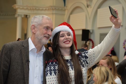 EDINBURGH, SCOTLAND - DECEMBER 16: UK Labour leader Jeremy Corbyn poses for a selfie with a volunteer at Nelson Hall Community Centre on December 16, 2018 in Edinburgh, Scotland. The UK Labour leader joined with Scottish Labour leader Richard Leonard and Deputy Scottish Labour leader Lesley Laird as they shared Christmas lunch with homelessness activists and Labour Supporters in Edinburgh. (Photo by Mark Runnacles/Getty Images)