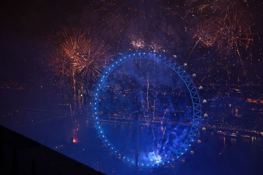 LONDON, ENGLAND - JANUARY 01: Fireworks explode over The London Eye and Elizabeth Tower near Parliament as thousands of revelers gather along the banks of the River Thames to ring in the New Year on January 1, 2019 in London, England. Parliament confirmed that after being silenced for renovation work since 2017, Big Ben's famous bongs would ring out at midnight again to welcome in 2019. (Photo by Dan Kitwood/Getty Images)