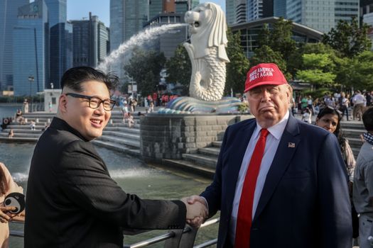 SINGAPORE - JUNE 08: Kim Jong Un impersonator, Howard X (L) and Donald Trump impersonator Dennis Alan (R) pose for photographers during a visit to the famous Merlion Park on June 8, 2018 in Singapore. The historic meeting between U.S. President Donald Trump and North Korean leader Kim Jong-un has been scheduled in Singapore for June 12 as a small circle of experts have already been involved in talks towards the landmark summit in the city-state. (Photo by Chris McGrath/Getty Images)