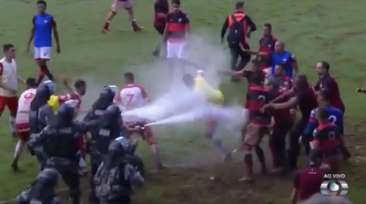 Brazilian football match descends into mass brawl as police use pepper spray to disperse crowd