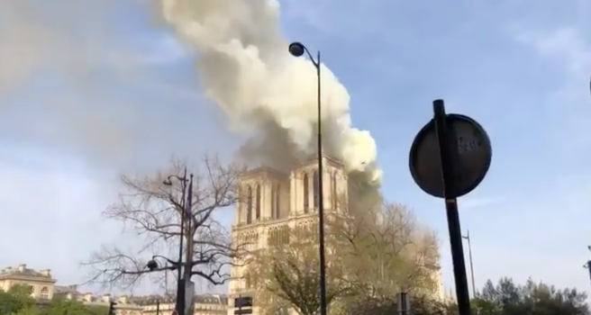 Smoke engulfs the spire of Notre Dame cathedral in Paris during a fire