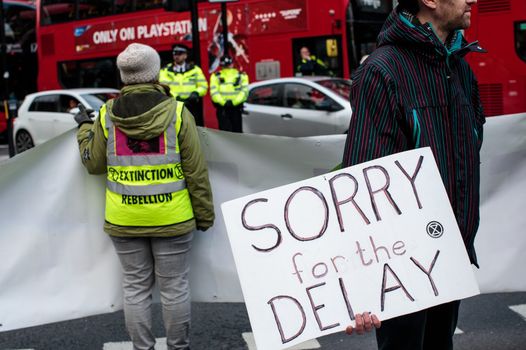 Climate protesters from the Extinction Rebellion group hold placards and banners as they block traffic in Elephant and Castle on November 21, 2018 in London, England. Environmentalists have brought traffic to a standstill across the capital today in a series of protests calling on the UK government to better tackle climate change. (Photo by Jack Taylor/Getty Images)