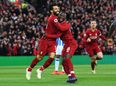 Naby Keita celebrates Liverpool’s comeback win at home in his kit