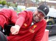 WATCH: Jurgen Klopp almost falls off bus during Liverpool’s trophy parade