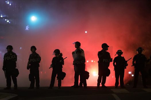 American police officers in riot gear during civil unrest after the killing of George Floyd