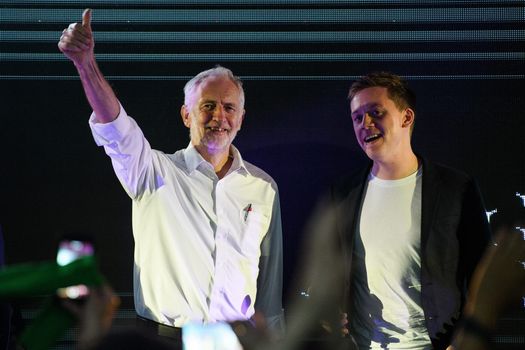 Jeremy Corbyn and Owen Jones stand together on stage