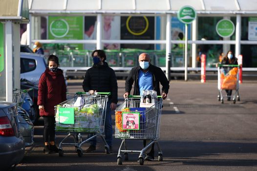 Shoppers at Asda wearing masks during the coronavirus pandemic, workers at the supermarket will get Boxing Day off