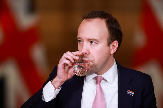 Matt Hancock sipping water at a Covid-19 press briefing