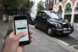 Uber to introduce holiday pay and pensions for UK drivers after court defeat