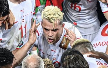 Xhaka necks a bottle of Coke before penalty shootout victory against France