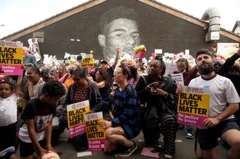 People take knee at vigil outside Rashford mural in Manchester