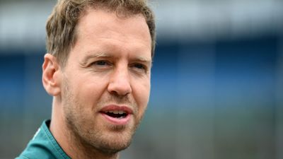 Sebastian Vettel helps tidy up Silverstone after fans leave it in a mess