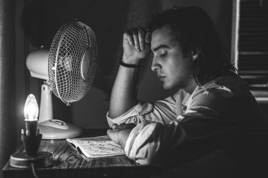 Man next to fan