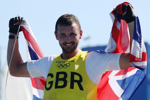 Giles Scott of Team Great Britain celebrates after winning gold in the Men's Finn class on day eleven of the Tokyo 2020 Olympic Games