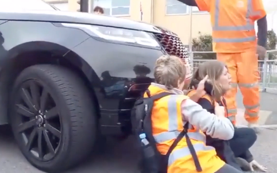 Woman begins driving over Insulate Britain protestors