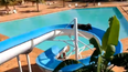 Cow escapes field, heads to resort, and gets stuck on water slide