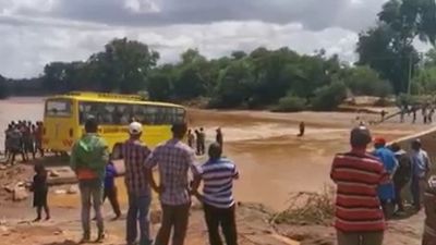 Shocking footage shows moment bus sinks as it crosses flooded road – leaving over 20 dead