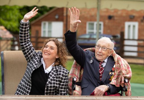 Colonel Tom Moore and his daughter Hannah celebrate his 100th birthday, with an RAF flypast provided by a Spitfire and a Hurricane over his home on April 30, 2020 in Marston Moretaine, England.