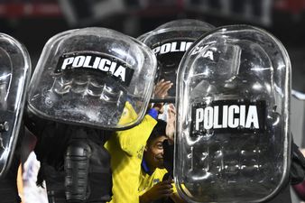 Boca Juniors players helped off pitch by riot police after Superclásico win