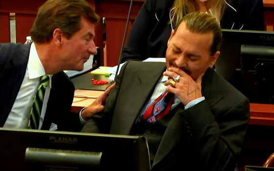 Johnny Depp laughing in court