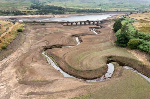 GLOSSOP, ENGLAND - JULY 21: In this aerial view the bed of the Woodhead reservoir can be seen as Summer water levels become reduced on July 21, 2022 in Glossop, England. Recent high demand for drinking water, record temperatures and reduced rainfall has seen some reservoirs in England at only 62% capacity. (Photo by Christopher Furlong/Getty Images)