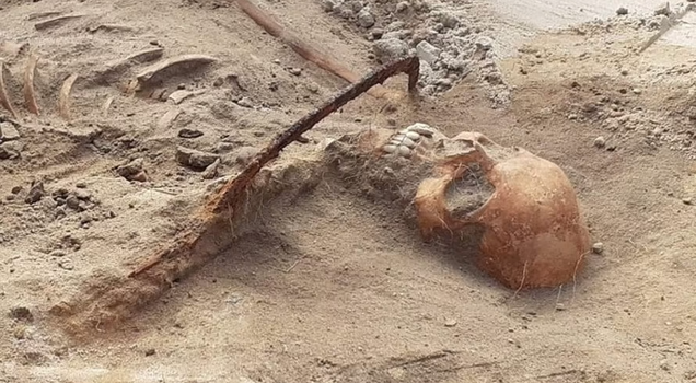 Remains of vampire discovered pinned down with sickle across throat