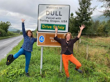 Elizabeth Leighton (left) and Emma Burtles (right) with the sing at Dull which reads: Dull, paired with Boring, Oregon, USA. See SWNS story SWNJdull; A woman who helped twin a tiny Scots village called Dull with Boring said its made it - more exciting. Elizabeth Leighton, 62, came up with the idea to link the village of Dull, Perthshire, with Boring in Oregon, after she passed through the town on a cycling holiday in 2012. Locals in Dull, which has a population of just 85, jumped at the idea to twin the two places  and said it has brought a flash of excitement to the tiny village ten years on. Dull has seen a surge in visitor numbers since 2012 and even had tourists from Boring come to celebrate the match. Elizabeth, who lives in nearby Aberfeldy, said visitors are regularly seen snapping selfies with a road sign which reads: Dull, paired with Boring, Oregon, USA.