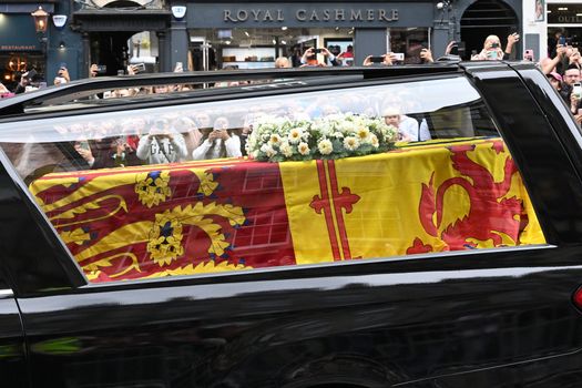 EDINBURGH, SCOTLAND - SEPTEMBER 11: The coffin carrying Queen Elizabeth II proceeds down The Royal Mile towards Holyroodhouse on September 11, 2022 in Edinburgh, Scotland. Elizabeth Alexandra Mary Windsor was born in Bruton Street, Mayfair, London on 21 April 1926. She married Prince Philip in 1947 and ascended the throne of the United Kingdom and Commonwealth on 6 February 1952 after the death of her Father, King George VI. Queen Elizabeth II died at Balmoral Castle in Scotland on September 8, 2022, and is succeeded by her eldest son, King Charles III. (Photo by Samir Hussein/WireImage)