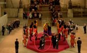 Queen’s guard collapses and falls from coffin podium