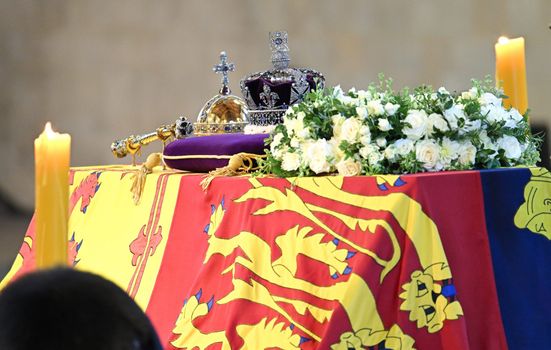 LONDON, ENGLAND - SEPTEMBER 17: The coffin carrying Queen Elizabeth II is draped in the Royal Standard and adorned with the Imperial State Crown and the Sovereign's orb and sceptre, rests in Westminster Hall for the Lying-in State on September 17, 2022 in London, England. Members of the public are able to pay respects to Her Majesty Queen Elizabeth II for 23 hours a day from 17:00 on September 14, 2022 until 06:30 on September 19, 2022. Queen Elizabeth II died at Balmoral Castle in Scotland on September 8, 2022, and is succeeded by her eldest son, King Charles III. (Photo by Karwai Tang/WireImage)