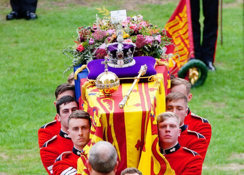 WINDSOR, ENGLAND - SEPTEMBER 19: Coffin bearers carry the coffin of Queen Elizabeth II into St George's Chapel on September 19, 2022 in Windsor, England. The committal service at St George's Chapel, Windsor Castle, took place following the state funeral at Westminster Abbey. A private burial in The King George VI Memorial Chapel followed. Queen Elizabeth II died at Balmoral Castle in Scotland on September 8, 2022, and is succeeded by her eldest son, King Charles III. (Photo by Ben Birchall-WPA Pool/Getty Images)