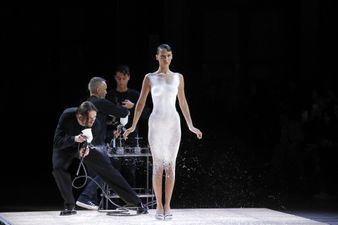 A naked Bella Hadid just had a dress sprayed onto her then strutted the catwalk in it